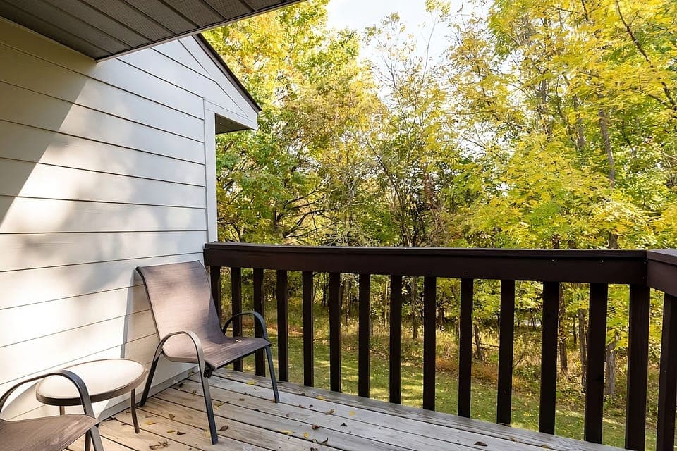 Sip morning coffee on the balcony overlooking tranquil trees.