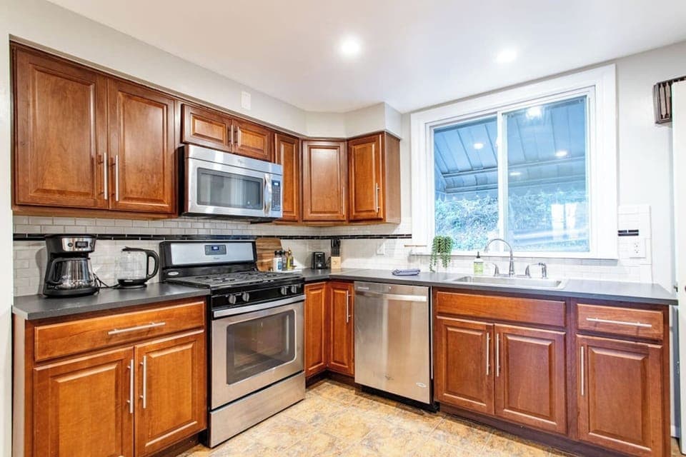 Fully equipped kitchen with modern appliances, including a stove, oven, refrigerator, microwave, and all the cookware and utensils you need to prepare your favorite meals.