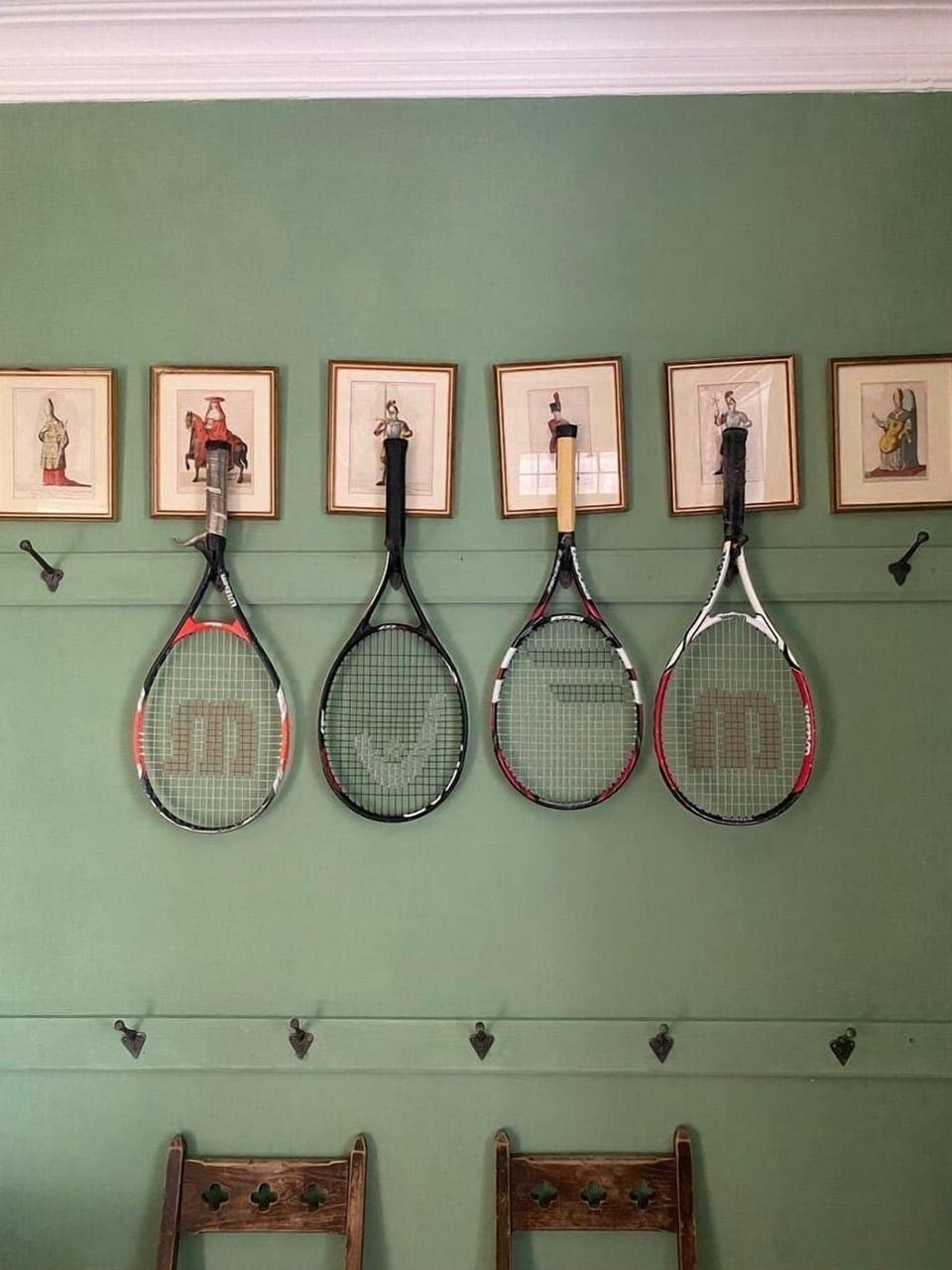 Tennis rackets, portraits, hooks in the green hall