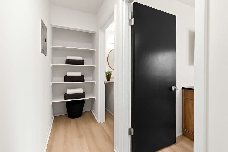 Walk-in closet with built-in shelving for convenient storage and organization during your stay.