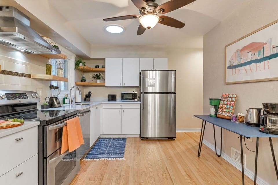 Compact and fully equipped kitchen with ceiling fan and coffee station