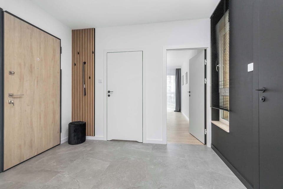 The living room's modern and stylish decor creates a welcoming atmosphere. 