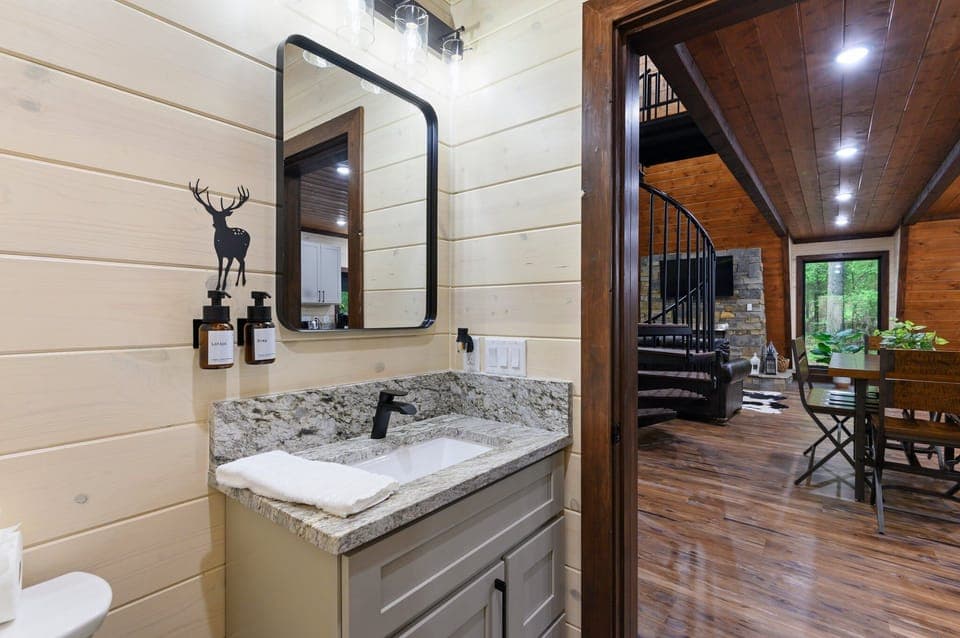 Freshen up in the half bath located behind the staircase in the living room.
