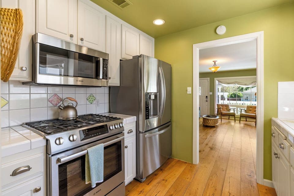 Remodeled cottage kitchen with new stainless steel appliances.