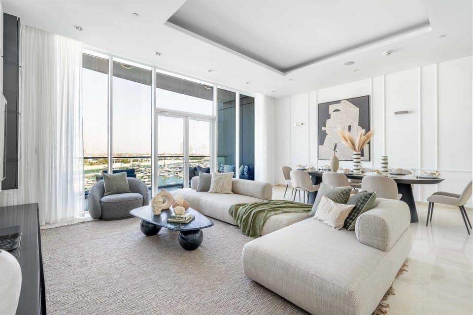 Stunning open plan lounge with floor to ceiling windows and sea view