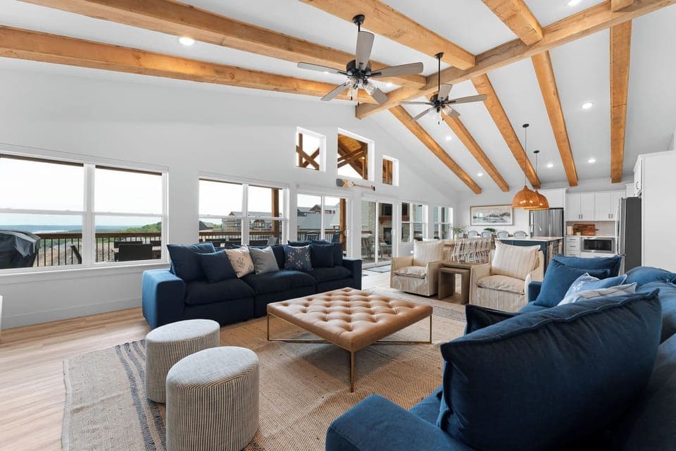 A grand open concept living space with rustic wood beams!