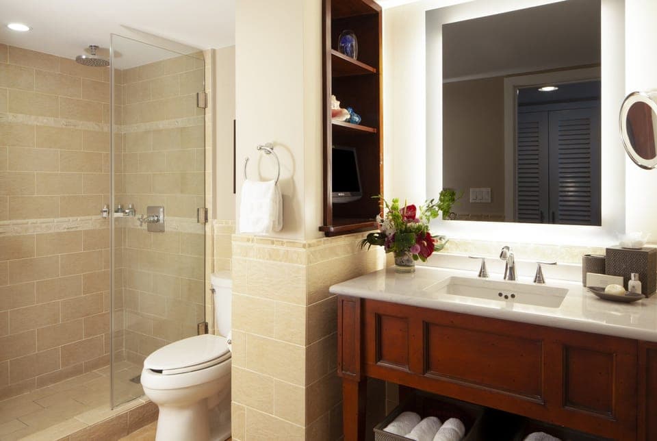Refresh under a rainfall shower in a spotless stone bath.