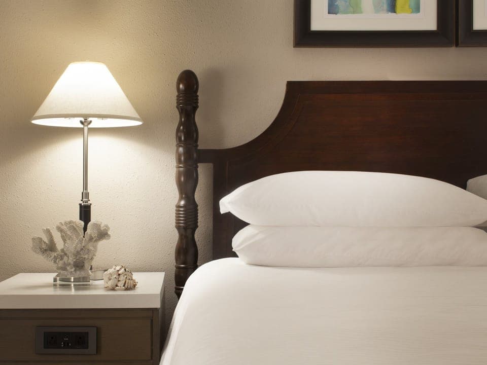 Drift off beside warm lamplight and plush, layered pillows.