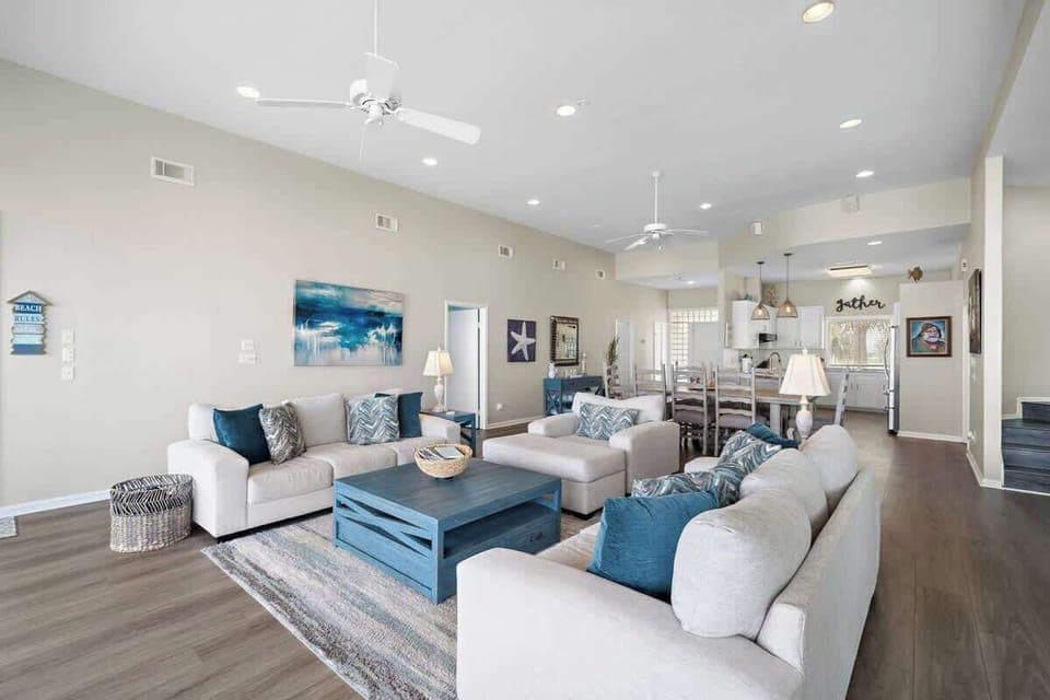 Bright living space with big, comfy sofas and plenty of natural light to enjoy.