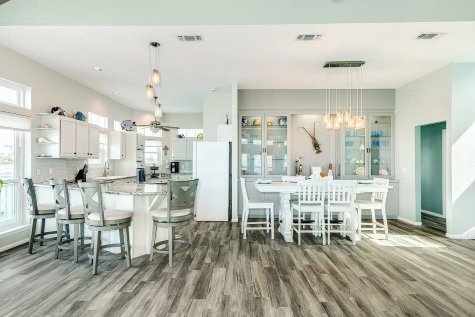 The living area leads to the adjacent dining table and kitchen