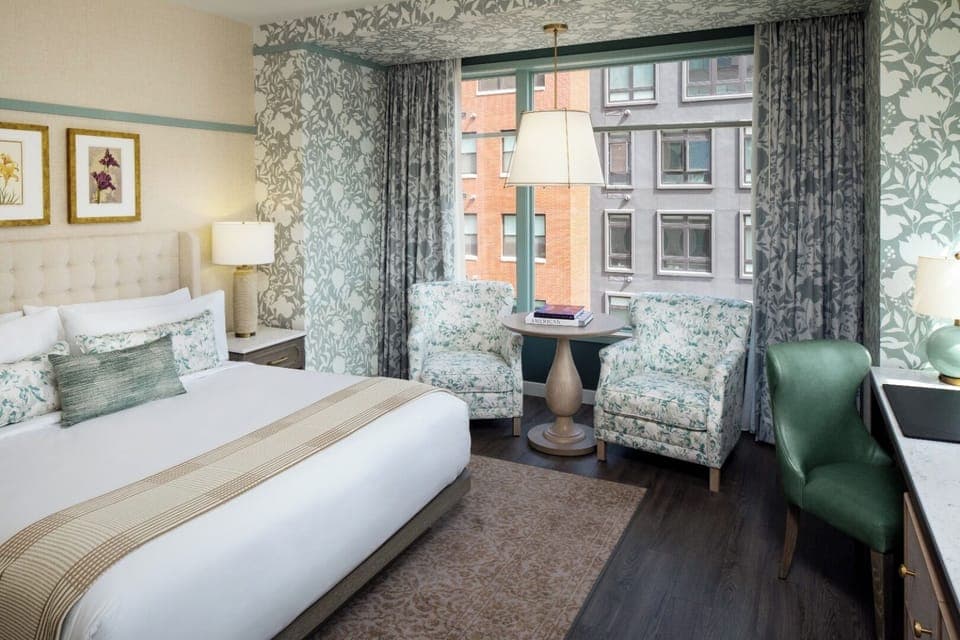 Unwind in a sunlit bedroom with cozy seating nook.
