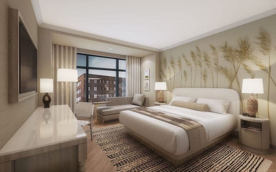 Sink into crisp linens in a serene, softly lit bedroom.