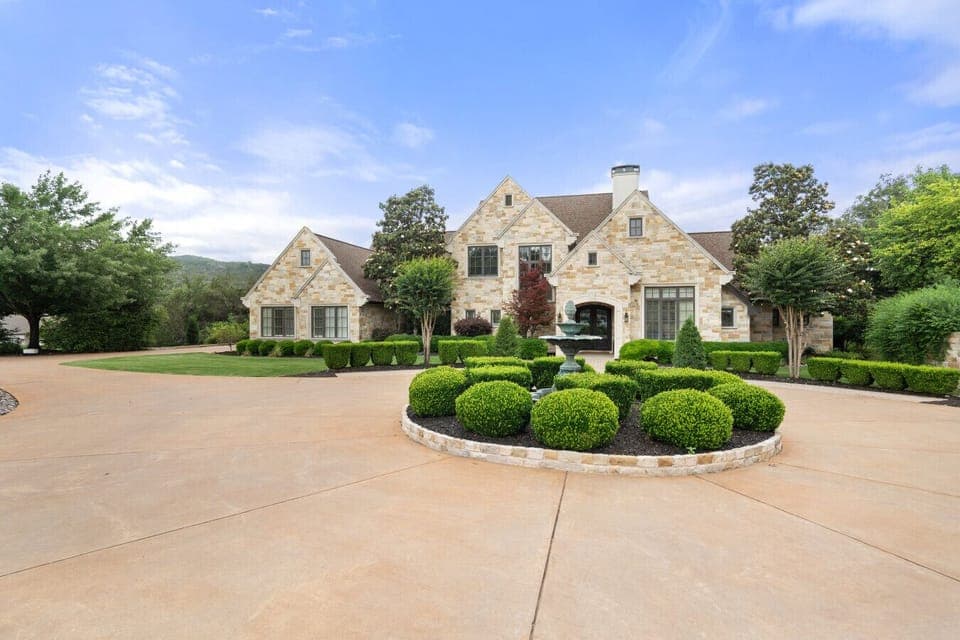 Elegant stone exterior with manicured landscaping and private entry.