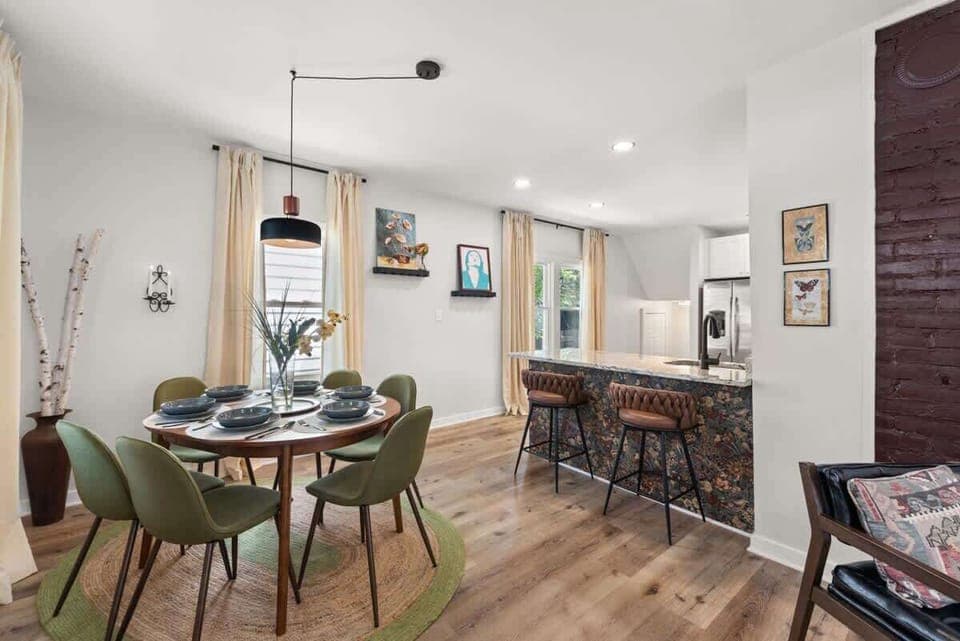 Gather 'round the table in this chic dining room with warm hardwood floors and cozy vibes. ️ Who's ready for a delightful meal? #HomeSweetHome