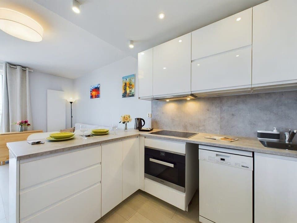 A bright kitchen with modern appliances, ample counter space, and sleek cabinetry for functionality.
