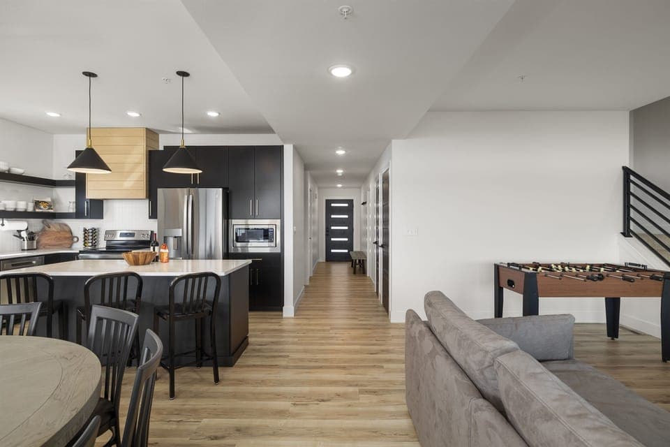 Main Level: Kitchen & Living Room w/ 85" TV, fireplace, and foosball table