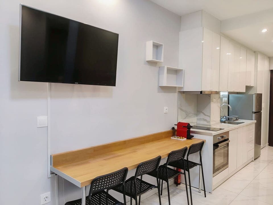 Desk, smart TV, coffee machine and kitchen