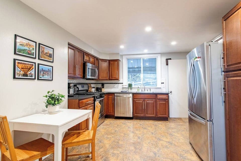 Spacious full kitchen featuring stainless steel and modern appliances.