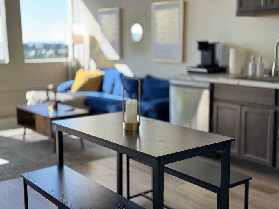 Cozy dining setup for four, fully equipped with dinnerware and kitchen essentials.