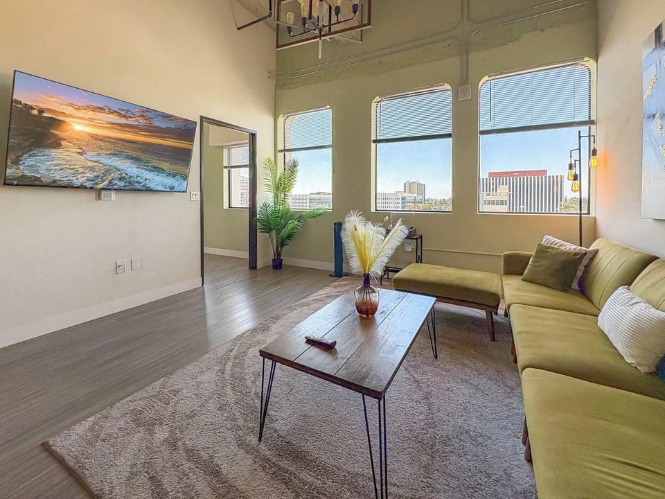 Living room with a sofa, Full-size air mattress, and a 65" Smart TV (Netflix, Hulu, and Disney+, we logged them remotely) included for free.