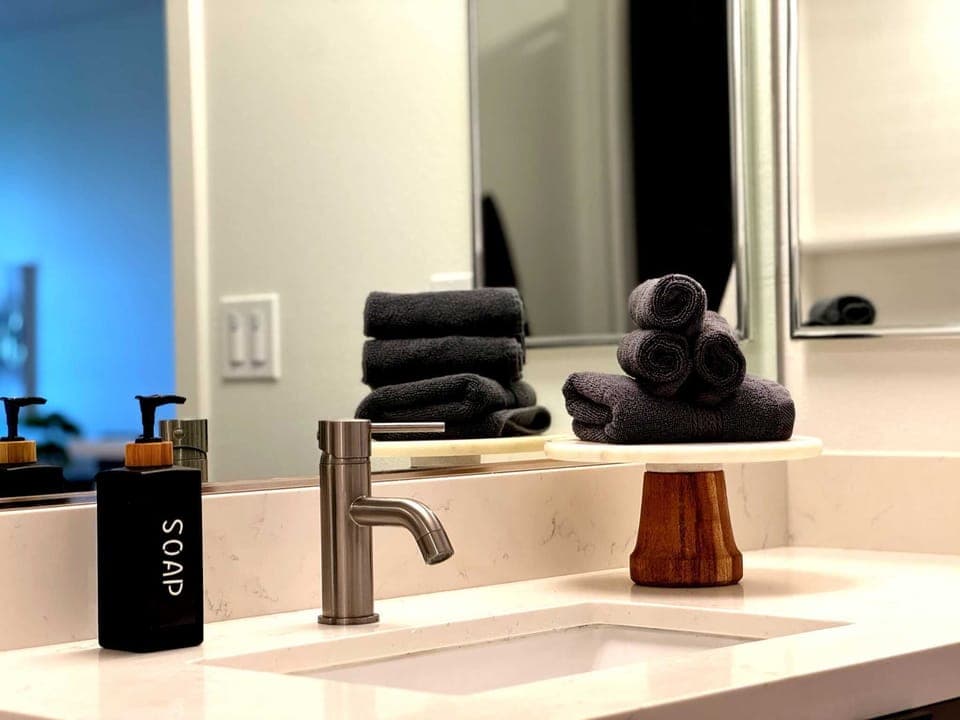 Modern bathroom amenities include bidet, blow dryer, a selection of complimentary toiletries, plush towels, shampoo, conditioner, body wash, and luxurious hand soap.