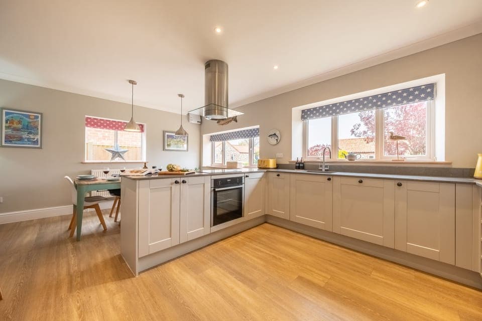 Ground floor: Kitchen/dining with electric oven and induction hob, fridge/freezer, dishwasher and microwave