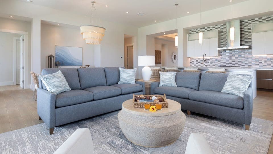 Comfy seating with 85" TV in large living room with 12 foot ceilings