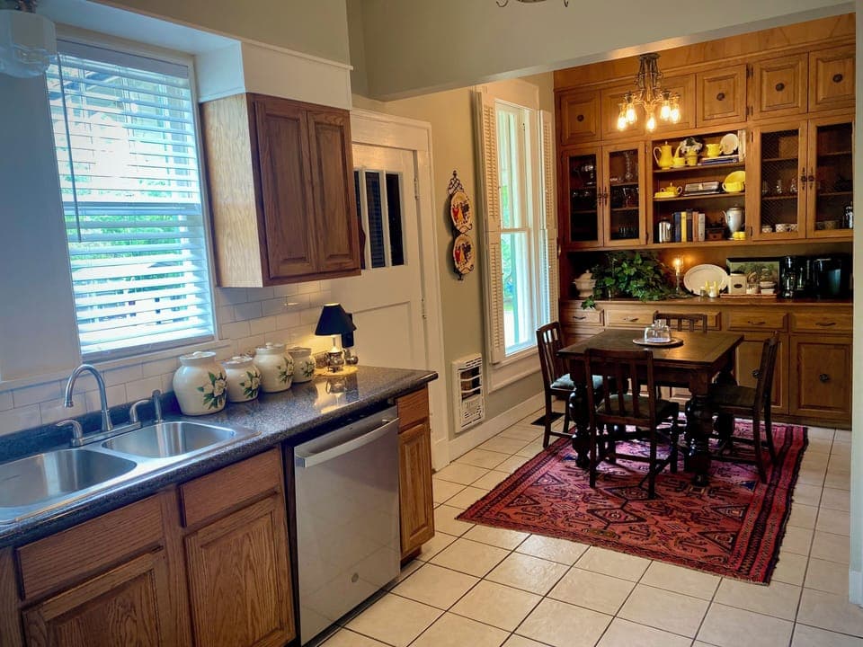 Breakfast area with draw leaf table and four chairs. Keurig and drip coffee pots