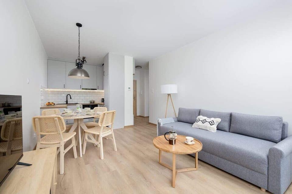 Bright and modern living space with a comfortable sofa and dining area.