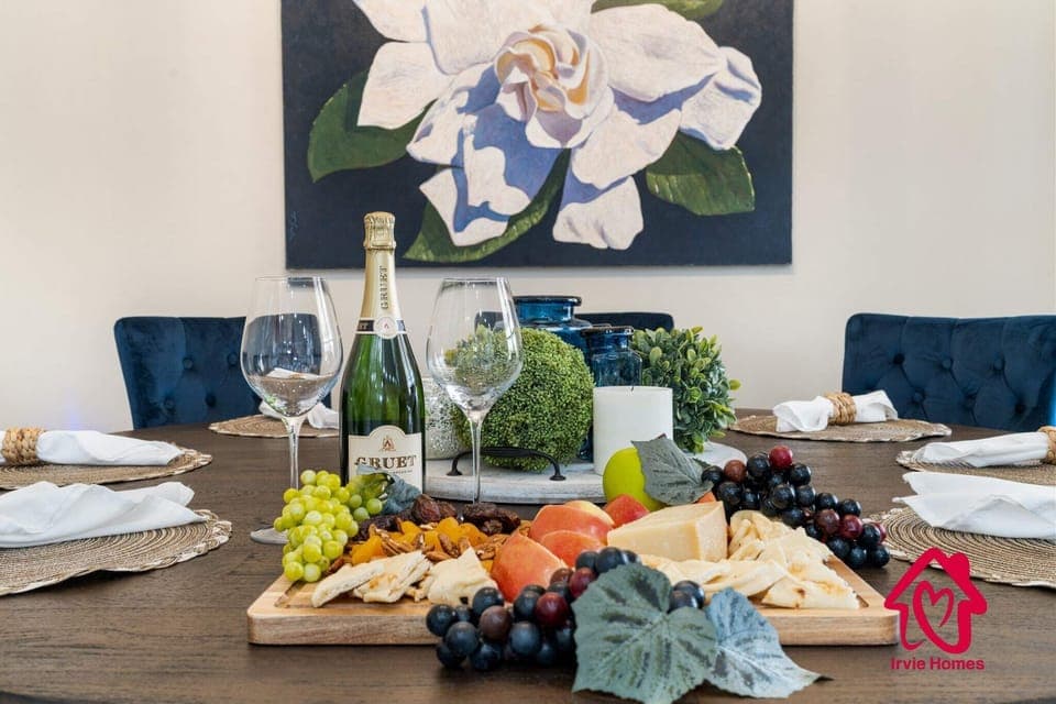 "Indulge in Elegance: Luxuriate in Irvie Homes' bespoke comfort with classy dining, fine wine, and artisanal cheese—your exclusive retreat awaits! #LuxuryStay #GourmetGetaway #IrvieHomesComfort"