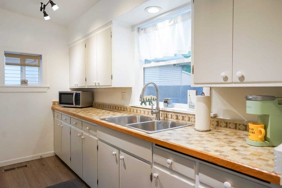 Our charming kitchen with retro tiles, basking in sunlight. The perfect bright and cheerful spot to prep any meal
