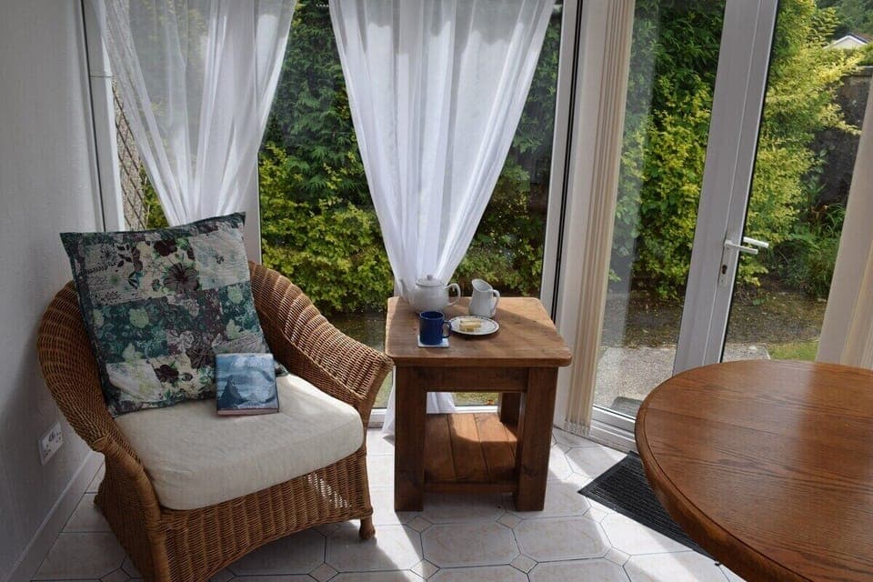 seating and dining area in the sunny conservatory with private garden views