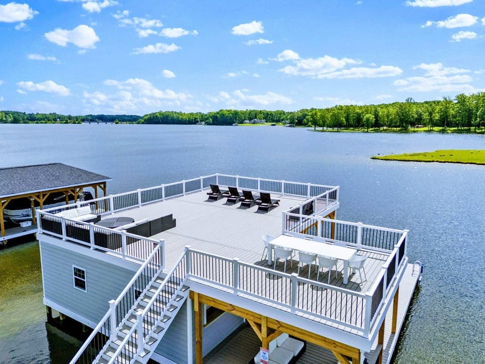Backyard - From above, the house and custom boathouse line up along your private shoreline, with the lake opening wide beyond.