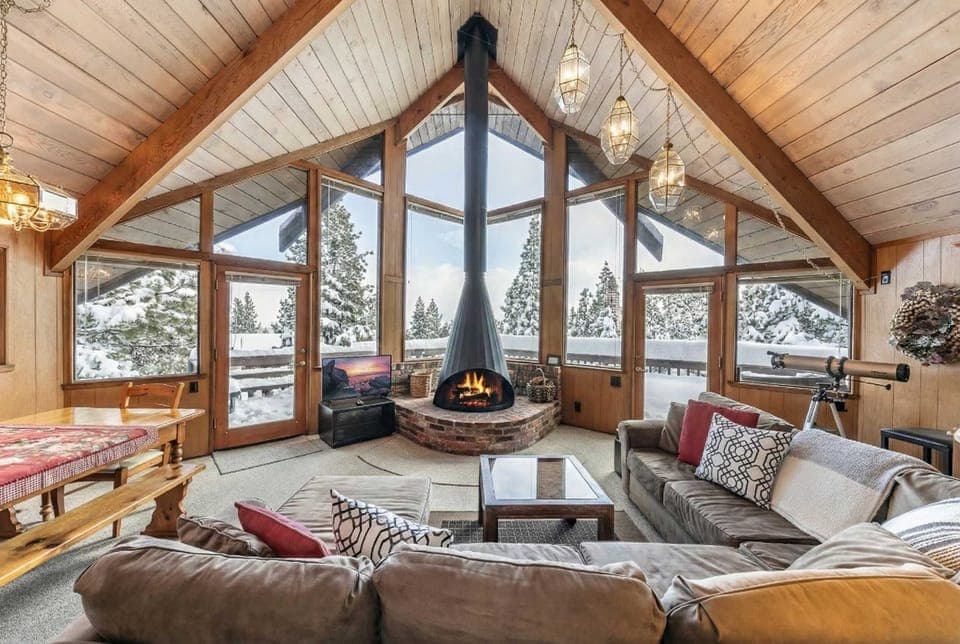 Living room: Wood fireplace, Smart TV, large l-shaped couch, access to deck