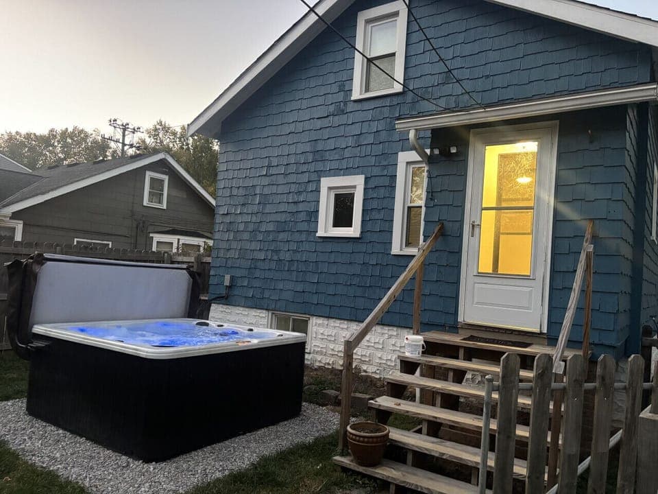 Private fenced yard with hot tub and cozy patio — your peaceful retreat minutes from shopping and dining.