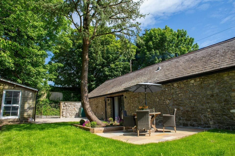 Patio doors leading onto furnished patio and lawn area