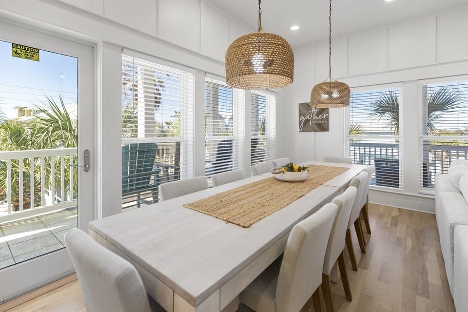 Gather around this bright dining space where woven pendant lights create warm ambiance for your memorable meals together.