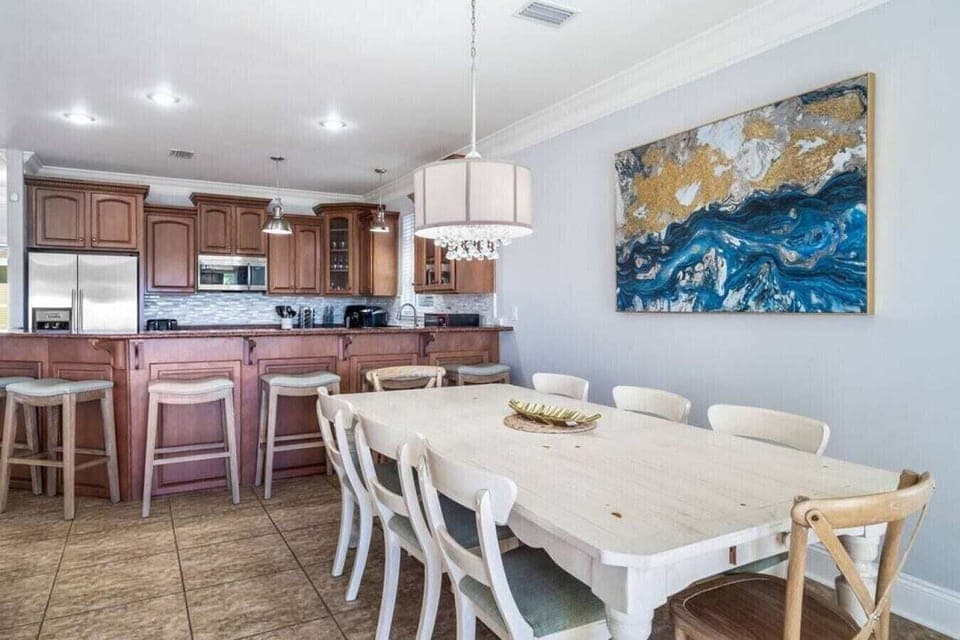 Your spacious open-plan dining area flows seamlessly into a fully-equipped kitchen, perfect for gathering and creating memorable meals together.