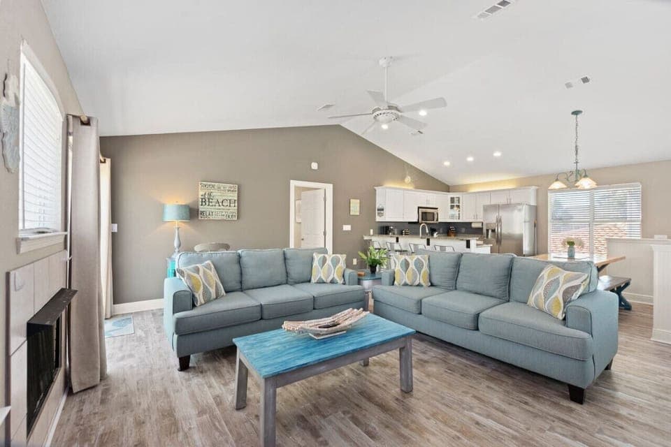 An open living room and kitchen with stunning views and plenty of natural light, creating a bright and airy space perfect for relaxing or entertaining!