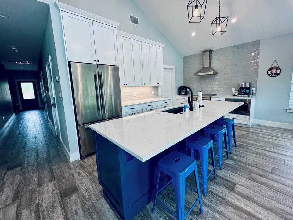 Spacious, modern kitchen with island seating and lake views.