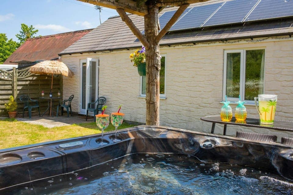 French doors leading from cottage to garden and hot tub area