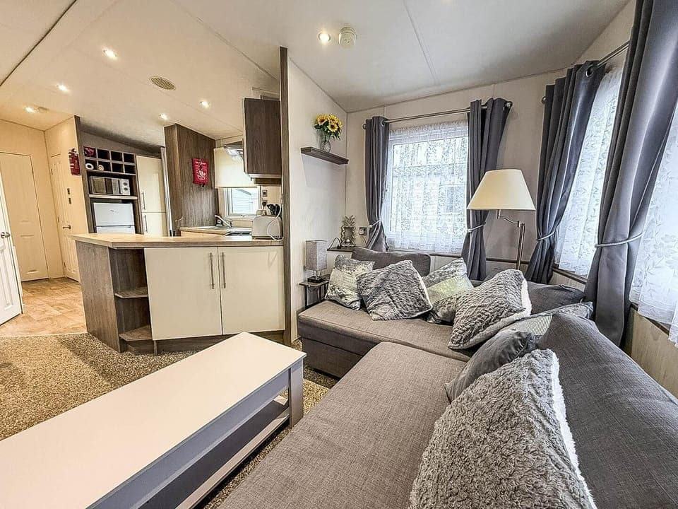 The living area is perfect for relaxing, with a dining table and comfortable seating.