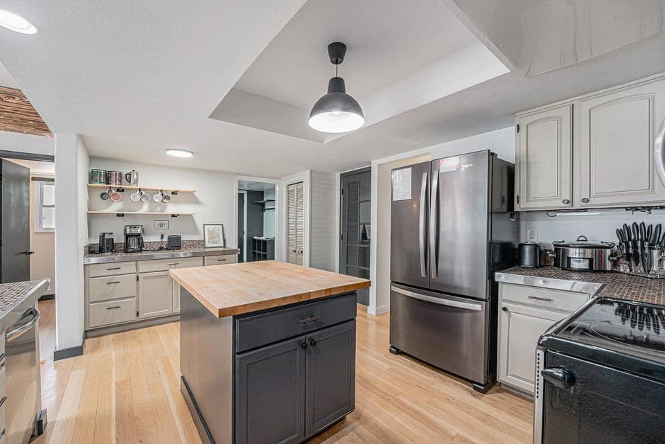 - Whip up meals in a stylish kitchen with a sleek island and stainless steel appliances
- Keep everything organized with open shelving and plenty of cabinet space
- Prep, cook, and dine with ease on gleaming wood floors and spacious countertops


