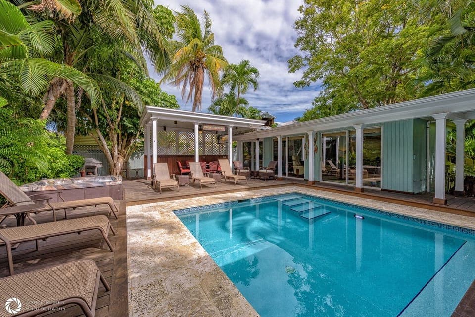 Private Pool and Hot tub with lounge chairs and covered seating area