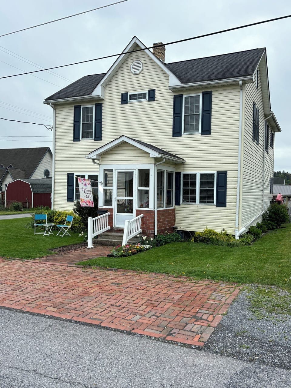 Front of house with up tothree parking spaces in brick area.