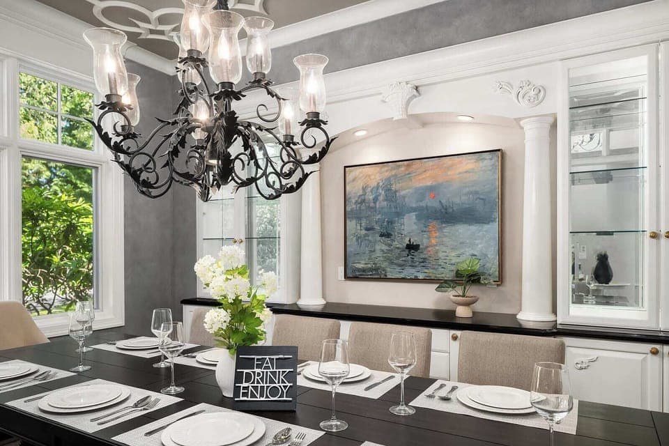 Elegant dining room with a stunning chandelier and a large dining table for special occasions.