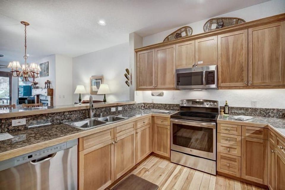 Gourmet kitchen equipped with modern appliances and elegant granite countertops, perfect for culinary adventures.