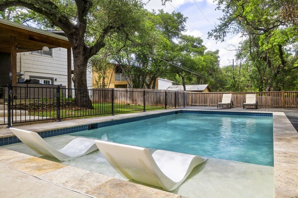 In-water lounge chairs for relaxing poolside on warm Texas afternoons
