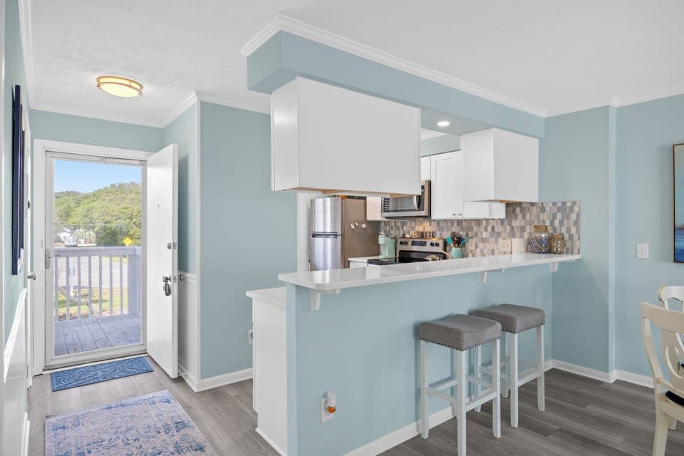 Front door entry way shows extra light, bar area. Indoor pool across the street