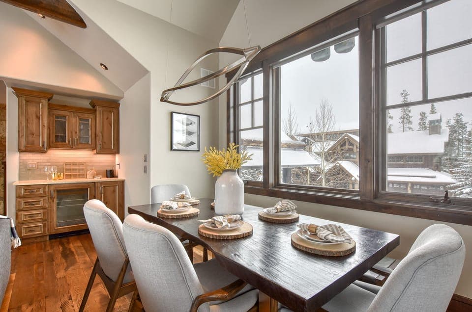 The dining area to the left of the couches. 